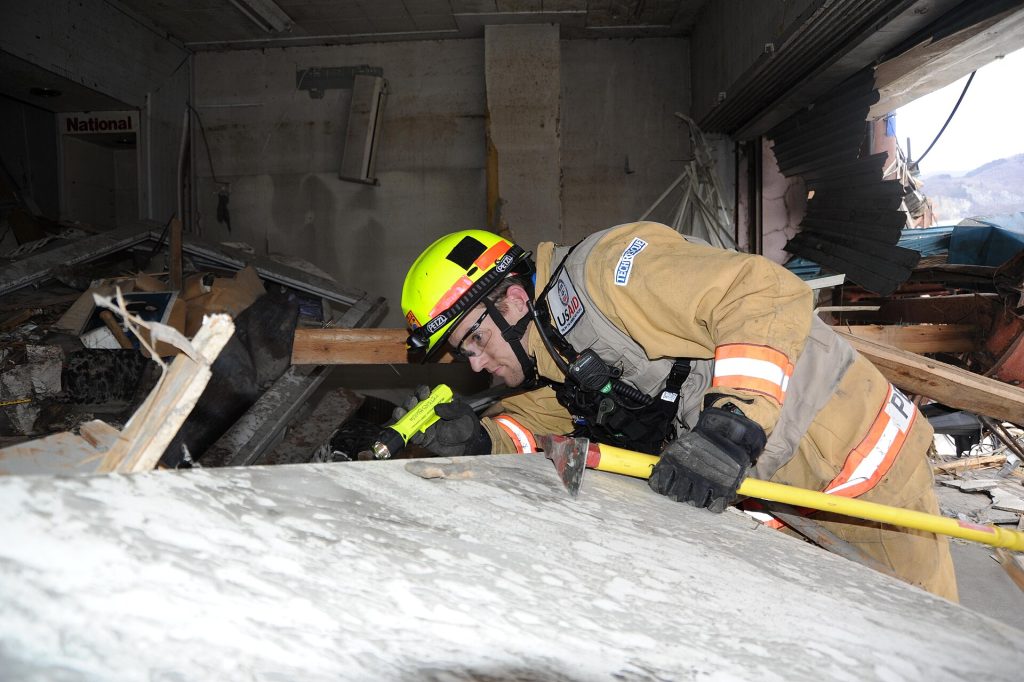 Rescue workers searching through disaster rubble